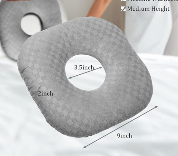 A white orthopedic CNH pillow with a round ear hole in the center