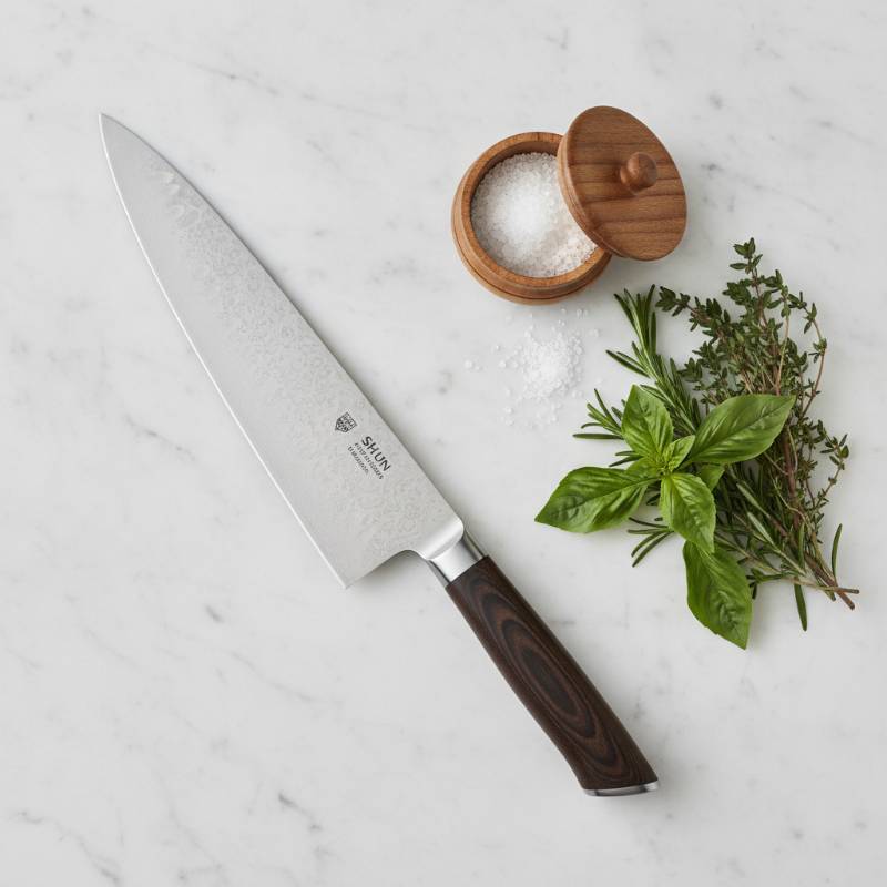 Shun Santoku knife resting on a clean kitchen counter