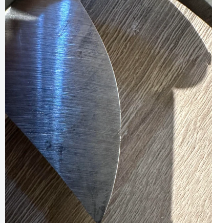 Sharpening a leather round knife on a whetstone and a leather strop